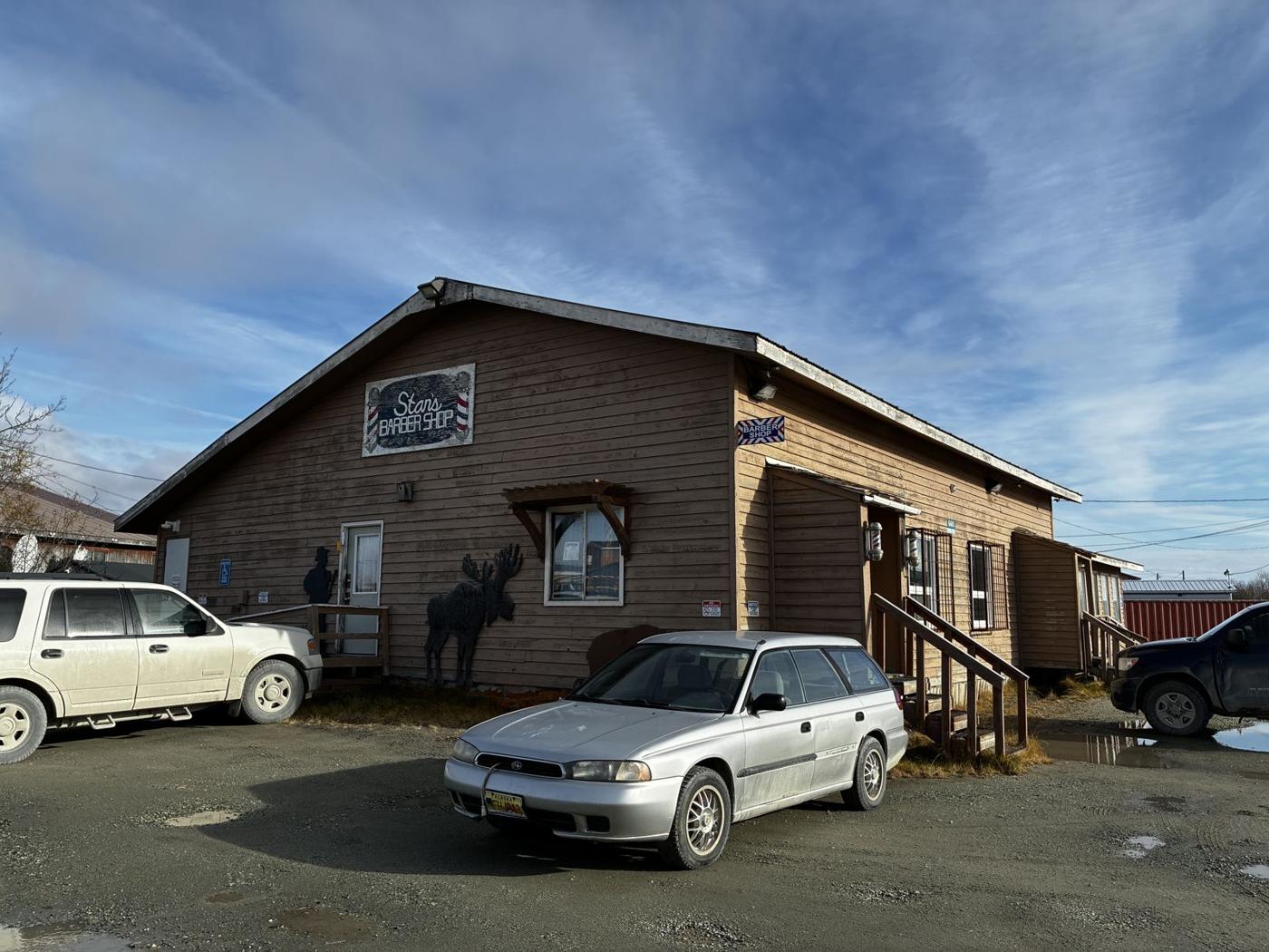 Stan's Barber Shop building with its painted sign and wooden moose